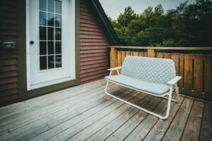 A modern grey composite deck built alongside a traditional natural wood deck in a Northern Virginia backyard.